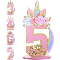 a pink birthday cake with unicorns and flowers on it, surrounded by numbers that spell out the number five