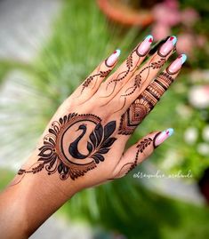 a woman's hand with henna tattoos on it