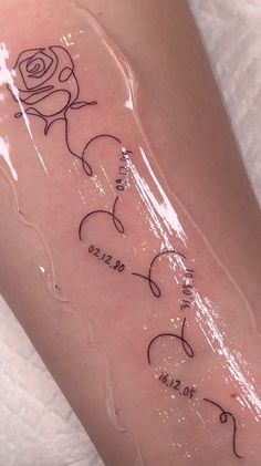 a woman's leg with tattoos on it and the word love written in cursive writing