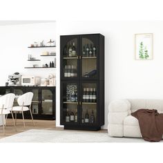 a living room filled with furniture next to a white chair and a wall mounted cabinet