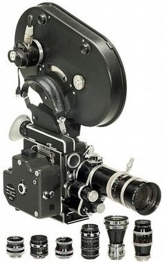 an old fashioned movie camera with several lens attachments