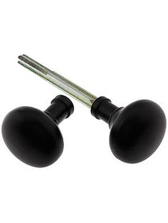 two black door knobs and a screw on a white background