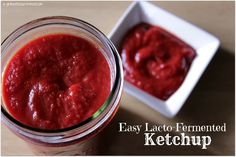 a glass jar filled with ketchup next to a white bowl