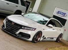 a white car parked in front of a building