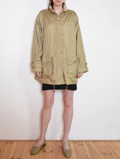 Cool vintage lightweight jacket / windbreaker- made  of textured, golden beige taffeta fabric. Loose parka fit, with drawstrings to regulate the waist and the bottom hem. Hidden zip with brass-colored rectangular snaps. Nice detail - rolled up sleeve cuffs with rounded patches decorated with snaps. Two large front pockets, one zipped "secret" front pocket, and some buttoned one inside. Gently padded arms give it a sporty elegance feel. Era: 90's, brand Windfield - Great Outdoor Wear Fabric: oute Oversized Beige Windbreaker For Fall, Oversized Beige Sporty Outerwear, Spring Nylon Long Sleeve Parka, Spring Nylon Parka With Long Sleeves, Beige Nylon Windbreaker With Pockets, Oversized Beige Windbreaker With Long Sleeves, Oversized Beige Long Sleeve Windbreaker, Fall Khaki Nylon Utility Jacket, Spring Nylon Utility Jacket With Long Sleeves