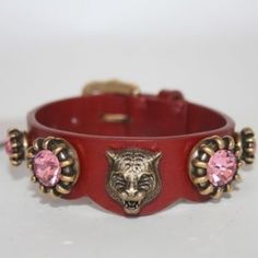 Beautiful Belt Bracelet By Gucci. Made In Red Leather, It Features An Aged Gold Metal Tiger Head With Pink Crystals Detailing. Buckle Closure. 3 Holes Adjustment. Total Length (From End To End): 8.5 Inches - 21.5 Cm. Max Circumference: 6.75 Inches - 17.2 Cm. Min. Circumference: 6 Inches - 15.2 Cm. Width: 0.75 Inches - 2 Cm. 'Gucci Made In Italy' Engraved Internally. Gucci Bracelet As Gift, Adjustable Gucci Bracelet For Gift, Designer Adjustable Gucci Bracelet, Gucci Luxury Adjustable Bracelets, Adjustable Gucci Bracelets For Formal Occasions, Luxury Adjustable Gucci Bracelets, Luxury Adjustable Gucci Bracelet, Gucci Adjustable Jewelry As Gift, Adjustable Luxury Gucci Jewelry