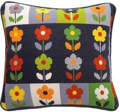 an embroidered pillow with colorful flowers on it