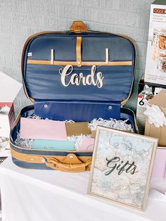 an open suit case sitting on top of a table next to a sign and other items