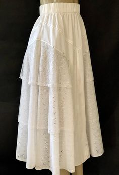 "Very hard to find vintage 1980s two piece white lace and eyelet jacket and midi skirt set by Mario Romano, Milano. Featuring a white jacket with attached front cotton twill shawl encrusted with Austrian crystals along the edge, gold metallic thread detailing, an eyelet body, high collar, and fabulous 5\" cuffs with 3 rhinestone snap closures. Jacket has a 6 rhinestone snap closure front. Shoulder pads. Two piece outfit features a full midi skirt with an elasticized waist, a front and back cotto Fitted Broderie Anglaise Skirt, White Broderie Anglaise Tiered Skirt, Spring Tiered Skirt With Broderie Anglaise, Eyelet Jacket, Midi Skirt Set, Full Midi Skirt, Vintage Elegant, White Jacket, Metallic Thread