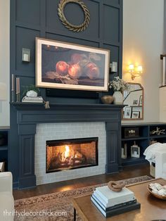 a living room filled with furniture and a fire place in front of a painting on the wall