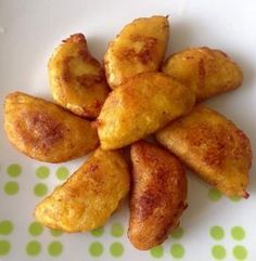 some fried food on a white plate with green polka dot tablecloth and dots around it