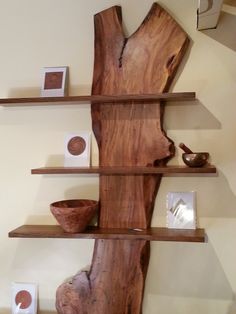 the shelves are made out of wood and have bowls on them, along with other items