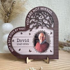 a wooden plaque with an image of a man on it and the words you are not missed