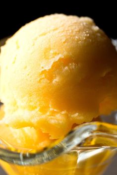 a scoop of ice cream sitting in a glass bowl