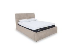 an upholstered bed frame with a mattress on top