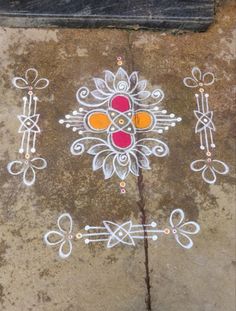 an artistic design is painted on the ground in white and red colors, along with other designs