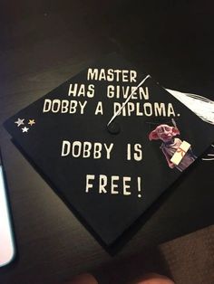 a black graduation cap with the words master has given dobby a diploma, dobby is free