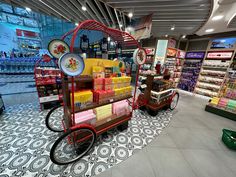 a shopping center filled with lots of different types of goods and items on display in carts