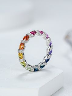 Experience the vibrant charm of our Rainbow Sapphire Ring, inspired by the majestic Ferris wheel. Crafted from 18K solid gold, this full eternity band features a stunning array of multicolor sapphires, creating a dazzling rainbow ombre effect. Perfect as a gift for her, this ring embodies elegance and joy, making it a timeless addition to any jewelry collection. Product details: Metal: 18K SOLID GOLD Gemstone type: natrual colorful OVAL sapphire Average band width: 4mm Gemstone measurement: 3mm* Luxury Rainbow Round Gemstones, Luxury Round Rainbow Gemstones, Multicolor Oval Sapphire Ring For Anniversary, Fine Jewelry Multicolor Oval Gemstones, Multicolor Oval Gemstones For Anniversary, Oval Multicolor Gemstones For Anniversary, Oval Multicolor Diamond Gemstones, Multicolor Oval Sapphire Ring, Round Multi-stone Cubic Zirconia Gemstones