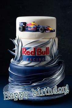 a birthday cake with a red bull racing car on it