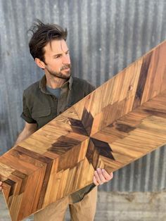 a man holding a large wooden object in his hands