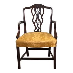 an antique chair with gold upholstered fabric on the back and armrests