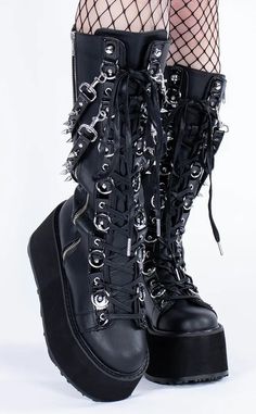 Dayum! These flatform boots are perfect for those who want some height with their stompy af boots without having to totter around on a heel. Black vegan leather. 3 1/2 inch (90mm) platform. Lace-up knee-high boots. Alternating O-Ring and eyelet lacing. Removable spike studded hanging straps. Outer side zip closure. U.S. women sizing - refer to the size chart for more info. Frankie Cosplay, Botas Goth, Pleaser High Heels, Mary Janes Flats, Alt Shoes, Punk Festival, Couture Heels, Platform Shoes Boots, Demonia Boots