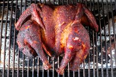 a chicken sitting on top of a bbq grill