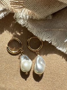 Beautiful earrings with freshwater pearls. Because the pearl is a natural freshwater pearl, there are no two pearls with the exact same shape. The gold hoop earrings add to her elegant look and the earrings go perfectly with an elegant outfit, but can also be worn every day. What makes our jewelry special? 🌊 The high-quality, gold-plated stainless steel makes the jewelry waterproof ✨ No discoloration, no green edges 🌿 Allergy friendly 🫀 Each piece of jewelry is selected with love and lovingly Wedding Jewelry Ideas For Bride Pearls, 14k Gold Filled Pearl Drop Earrings For Anniversary, Everyday Teardrop Pearl Pendant Earrings, Pearl White Drop Earrings Made Of Mother Of Pearl, Pearl White Drop Earrings In Mother Of Pearl, Everyday Pearl Drop Jewelry, Everyday Drop Pearl Jewelry, Everyday Pearl Pendant Drop Earrings, Pearl Drop Earrings With Pearl Charm