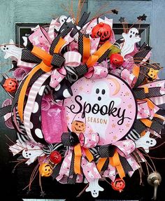 a halloween wreath is hanging on the front door for someone to welcome their loved ones