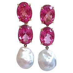 18kt Yellow Gold Elegant Three Stone Drop Earrings with two faceted Pink Topaz and Baroque Pearl. The Earrings measure 2 1/4 in length. The earrings can be made for Clip Earring or Pierced Earrings. These earrings can be made for Clip or Pierced earrings. The Bespoke Collection is made to order to your ring size. You may select whichever color stones you would like to match your outfit or your mood! Please contact us with any questions you may have. Christina Addison Fine Jewelry NYC Spiral Jewelry, Pink Pearl Earrings, Ruby Earrings Studs, Stone Drop Earrings, Sapphire And Diamond Earrings, Hammered Hoop Earrings, Color Stones, Pink Topaz, Ruby Earrings