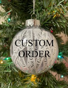 a christmas ornament with the words custom order on it hanging from a tree