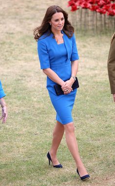 the duke and duchess of cambridge are seen walking in their blue outfits at an event