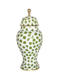 a white and green ceramic urn with gold trimmings on the top, sitting against a white background