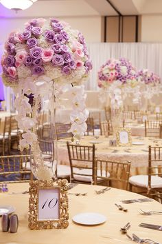 the centerpieces are filled with purple and white flowers