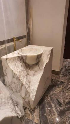 a marble sink sitting on top of a counter