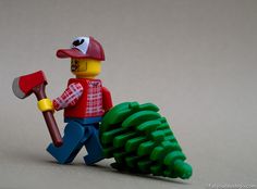 a lego figurine is holding a shovel and a pine cone