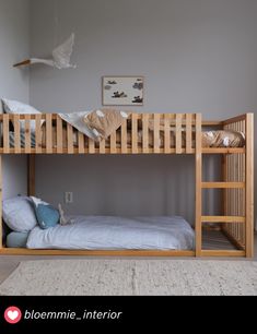 a wooden bunk bed sitting in a bedroom next to a white rug on the floor