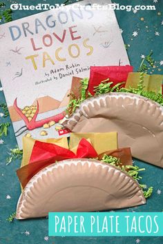 paper plate tacos are sitting on the table next to a dragon's tail book