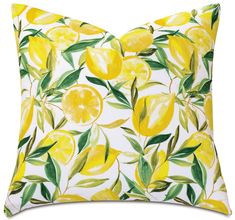 a yellow pillow with lemons and leaves on it