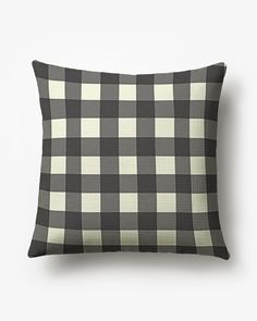 a black and white checkered pillow on a white background