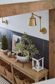 a potted plant sitting on top of a wooden shelf next to baskets and lamps