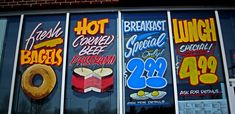 several signs on the side of a building advertising doughnuts and other pastries