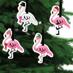 flamingos are hanging from the branches of a christmas tree