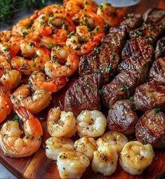 there are many different types of meat and shrimp on this platter that is ready to be eaten