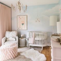 a baby's room with pink and white decor, including a crib, rocking chair, rugs, lamps, and pictures on the wall