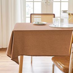 a dining room table with a brown cloth on it