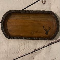 a wooden tray with a deer head on the bottom and antlers drawn on it