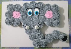 an elephant made out of cupcakes sitting on top of a card