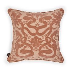 an orange and brown decorative pillow on a white background